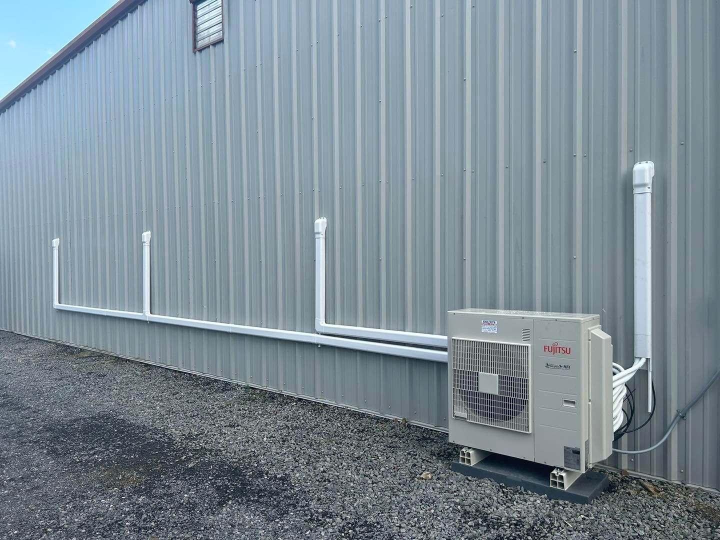 Gray Armstrong air conditioning unit outdoors.