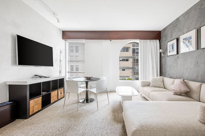 A living room with a couch and a flat screen tv