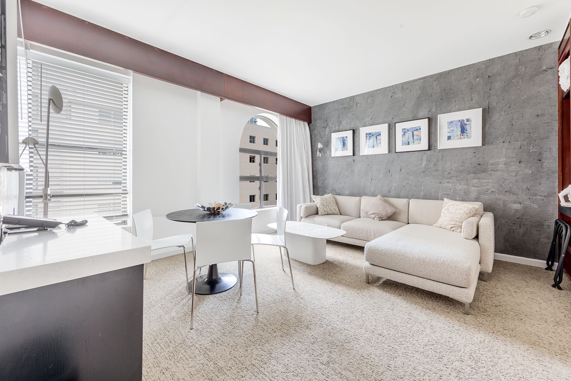 A living room with a couch , table and chairs