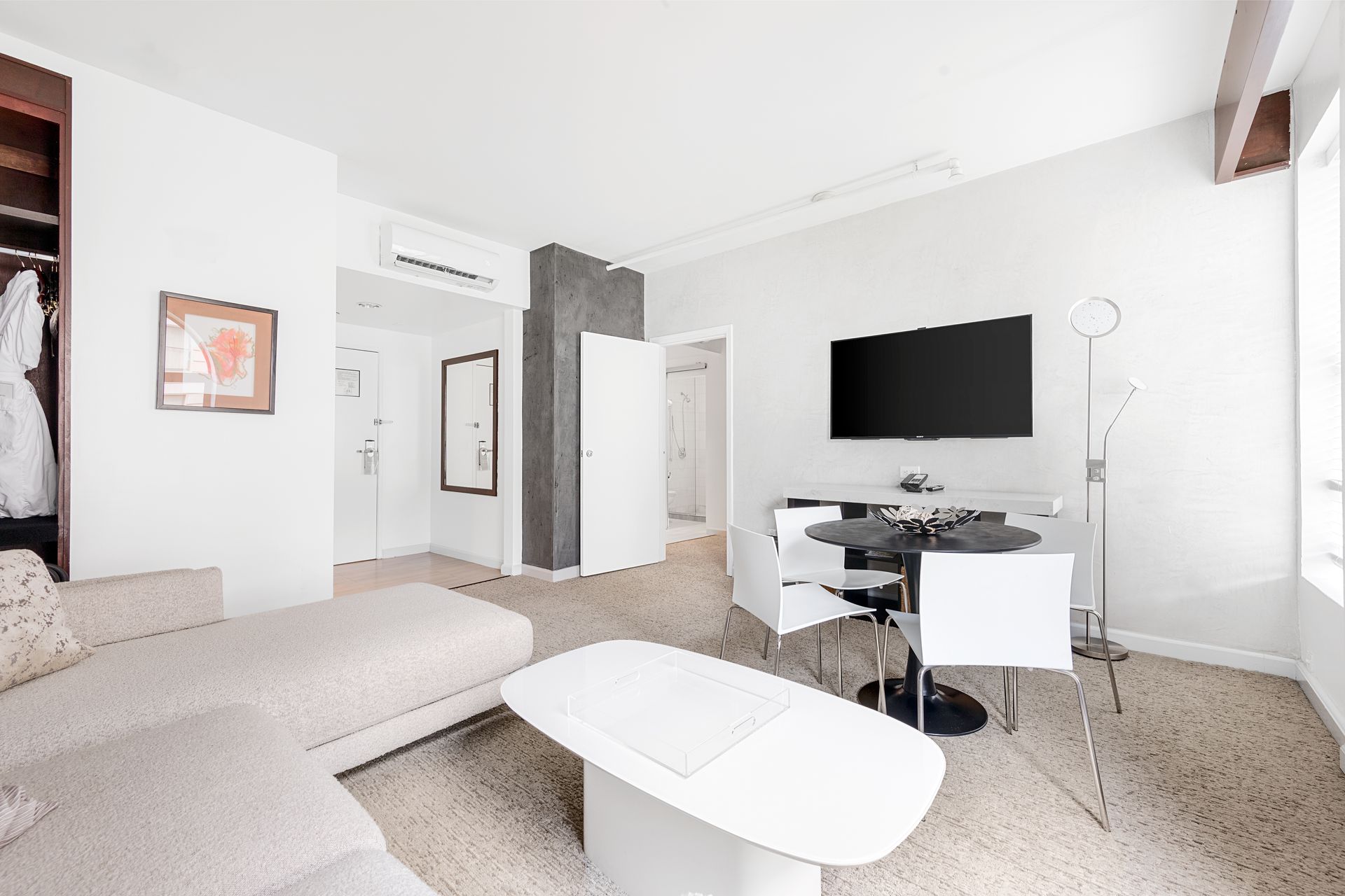 A living room with a couch a table and a flat screen tv