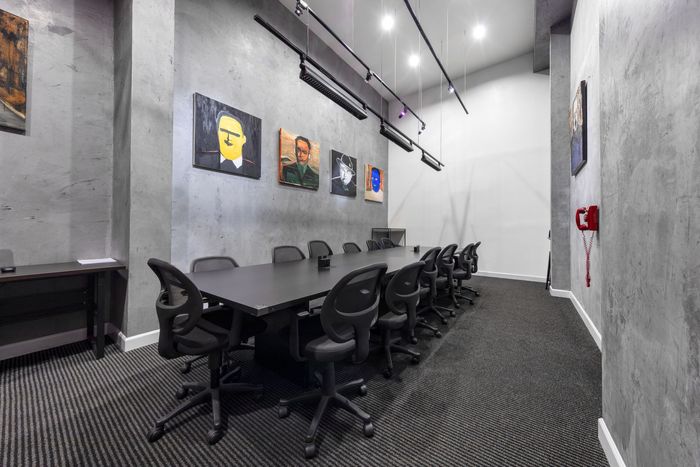 A conference room with a long table and chairs.