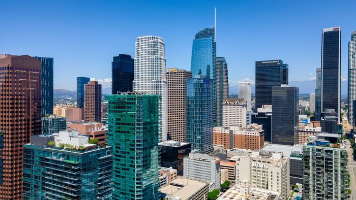 An aerial view of a city skyline with lots of tall buildings.