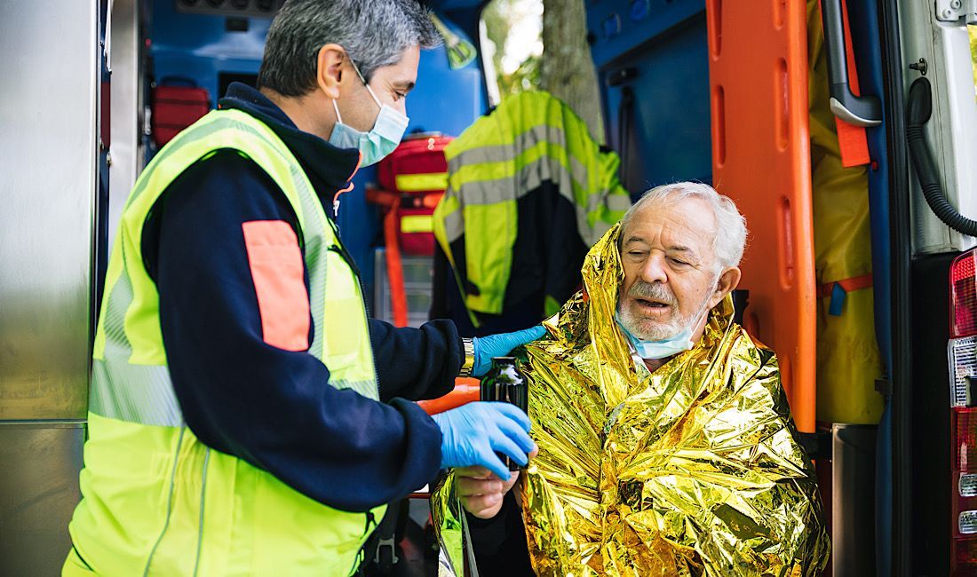Paramedic assisting an elderly man with hypothermia in Pittsburgh, PA