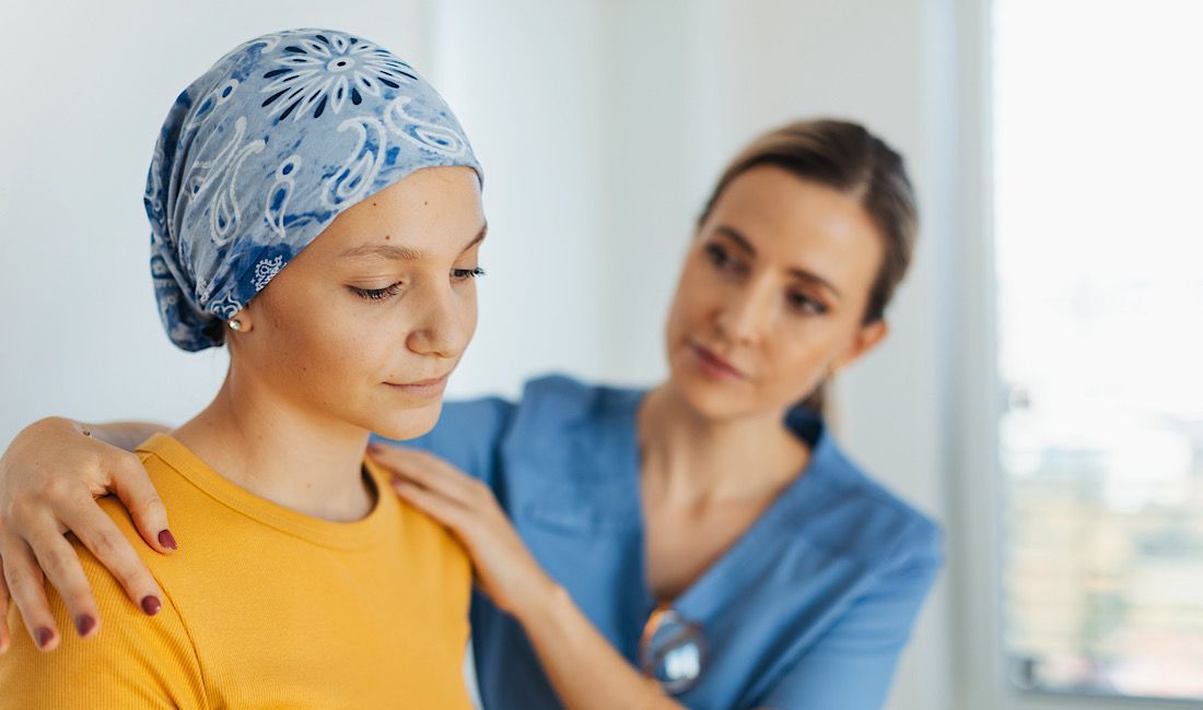 Healthcare provider consoling sick patient who has been diagnosed with cancer.