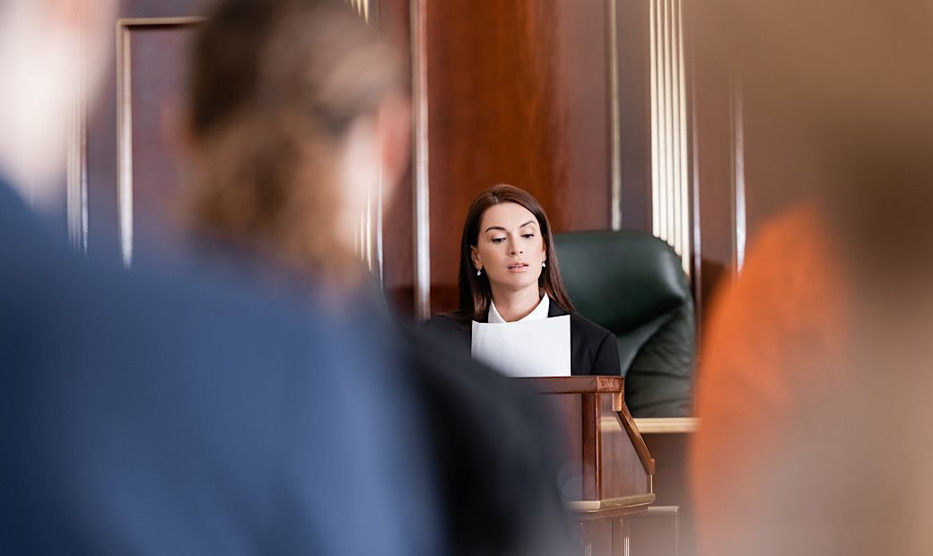 prosecutor reading lawsuit in court 