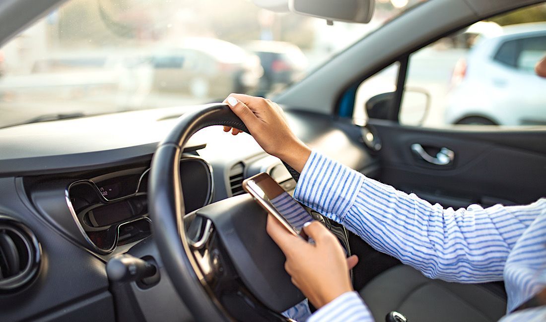 Woman on phone while driving, distracted driving in Pittsburgh, PA