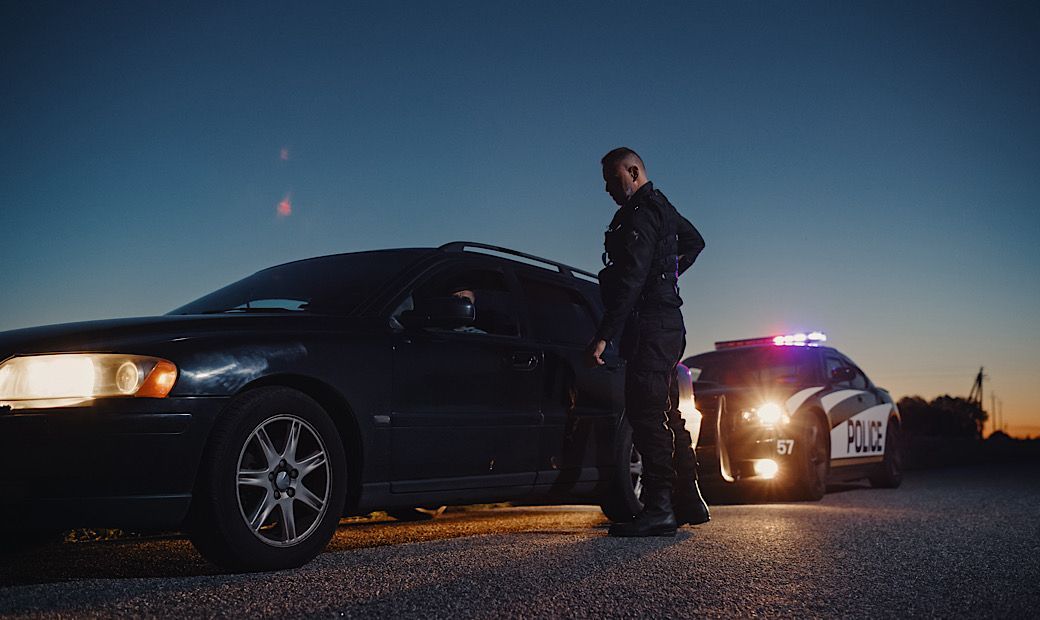 male in car pulled over by police officer for drinking and driving