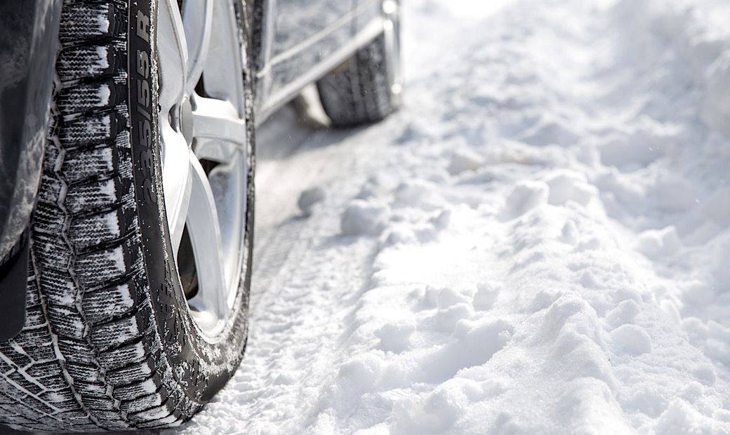 driving car in the winter with heavy snow on ground