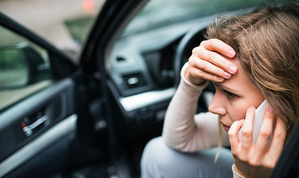 distressed woman on phone after car accident