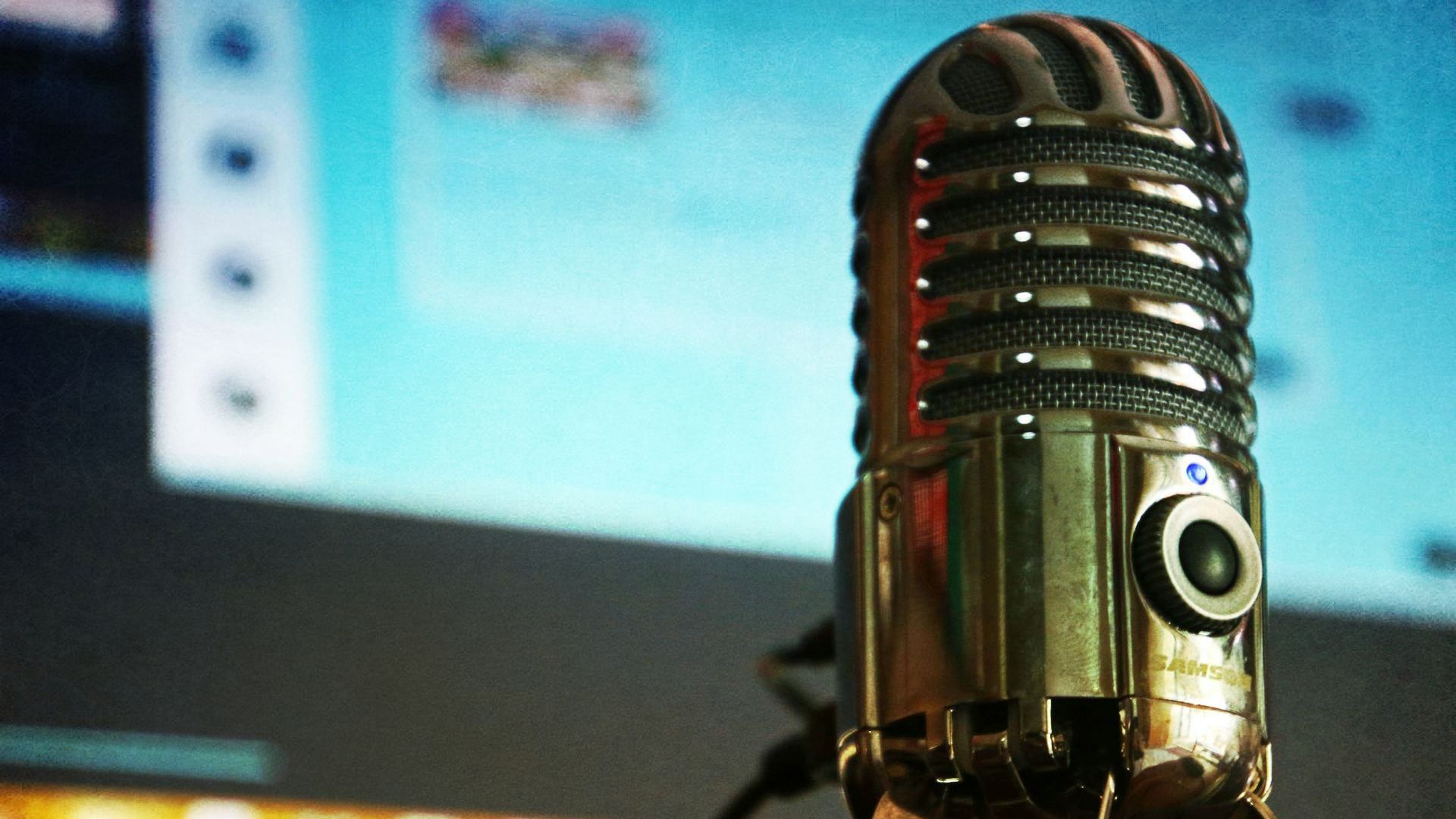 A close up of a microphone in front of a computer screen