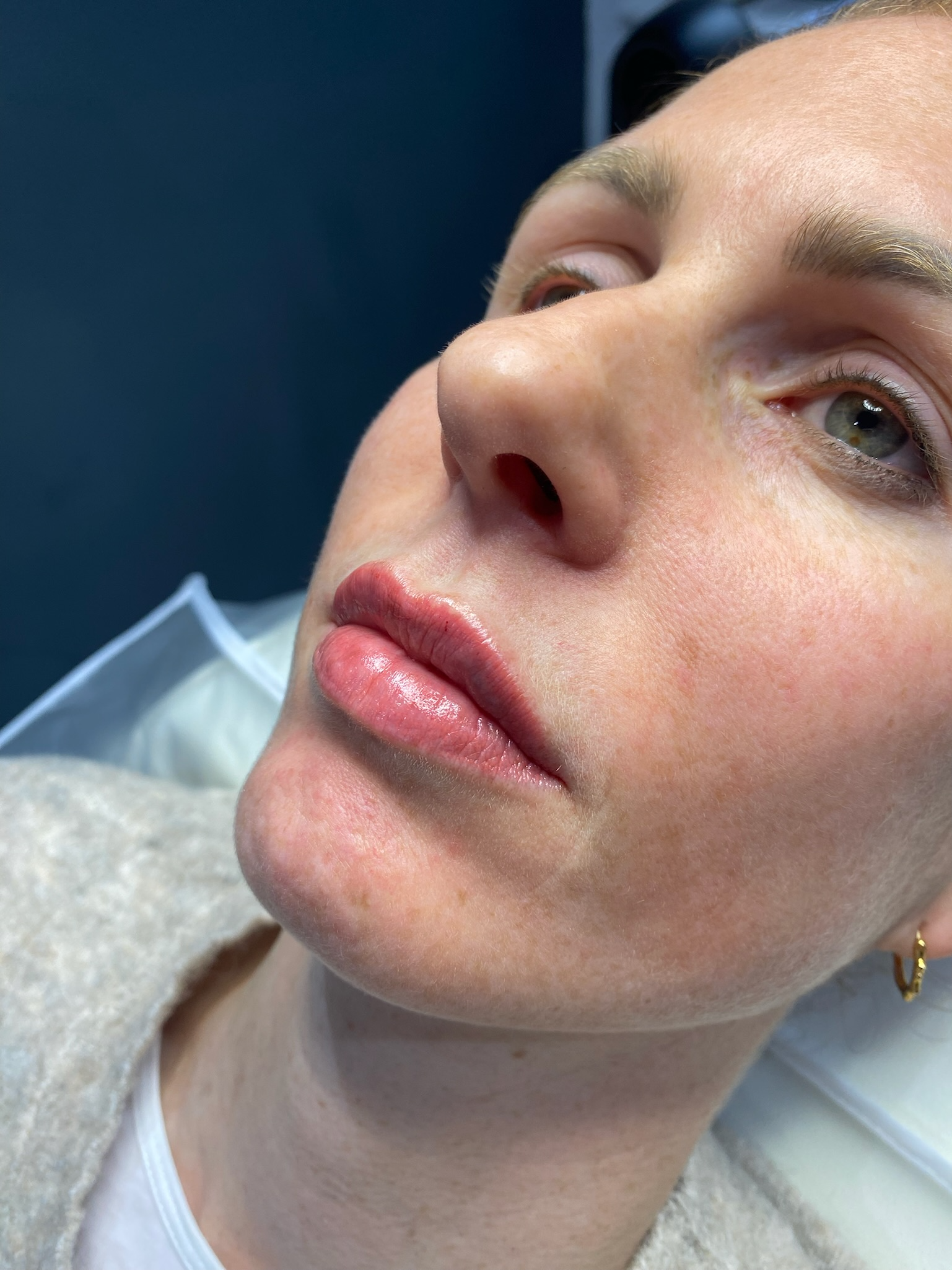 A close up of a woman 's face with her eyes closed.