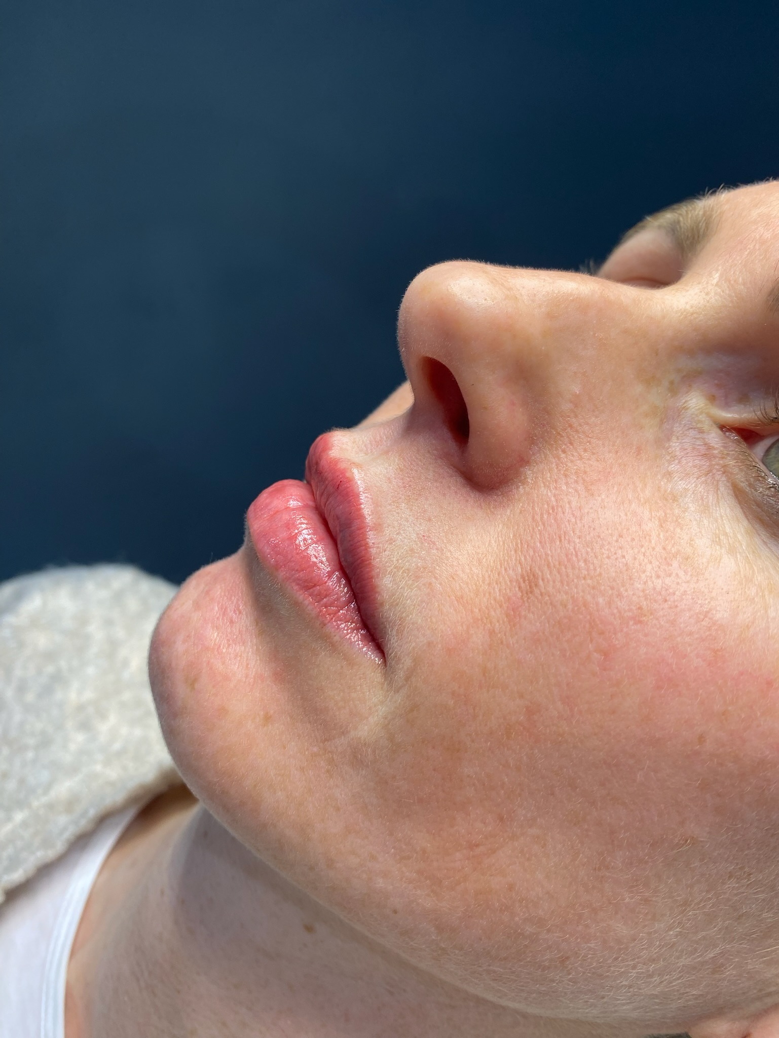 A close up of a woman 's face with her eyes closed.