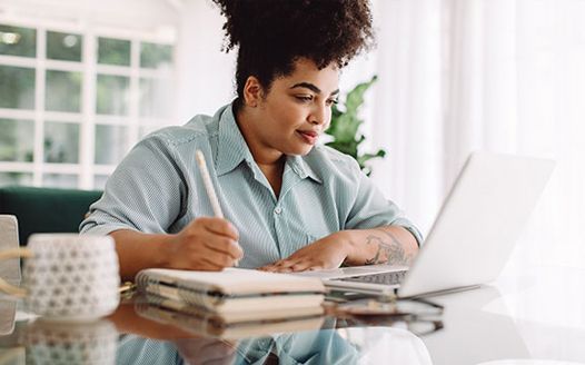 Internal auditor analyzing financial reports for an outsourcing vs. co-sourcing comparison.