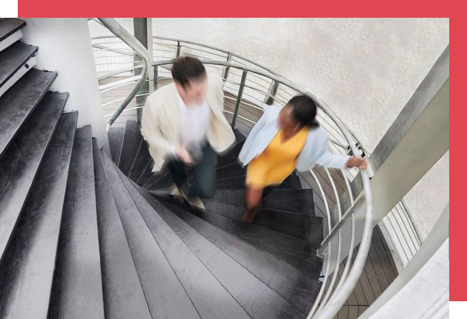 Coworkers having a meeting while walking up stairs.