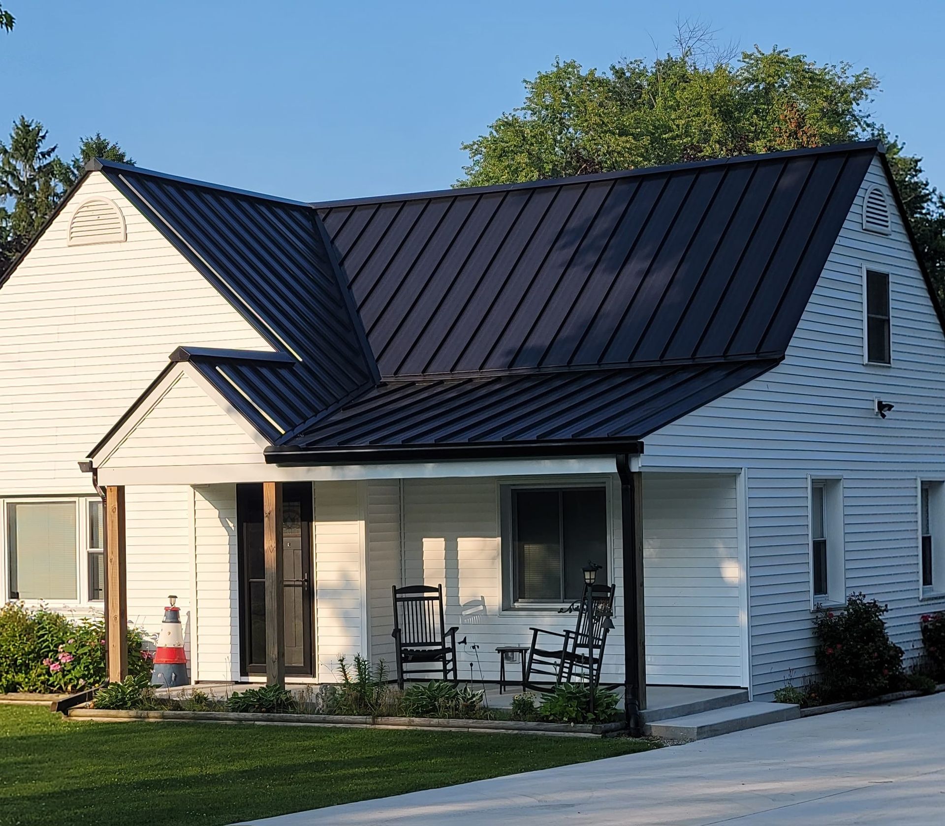 White house with seam metal roof — Croswell, MI — Parraghi Roofing & Sheet Metal, LLC