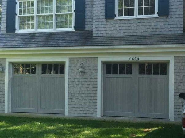 Blue House With Wooden Door - Garage Door in Hyannis, MA