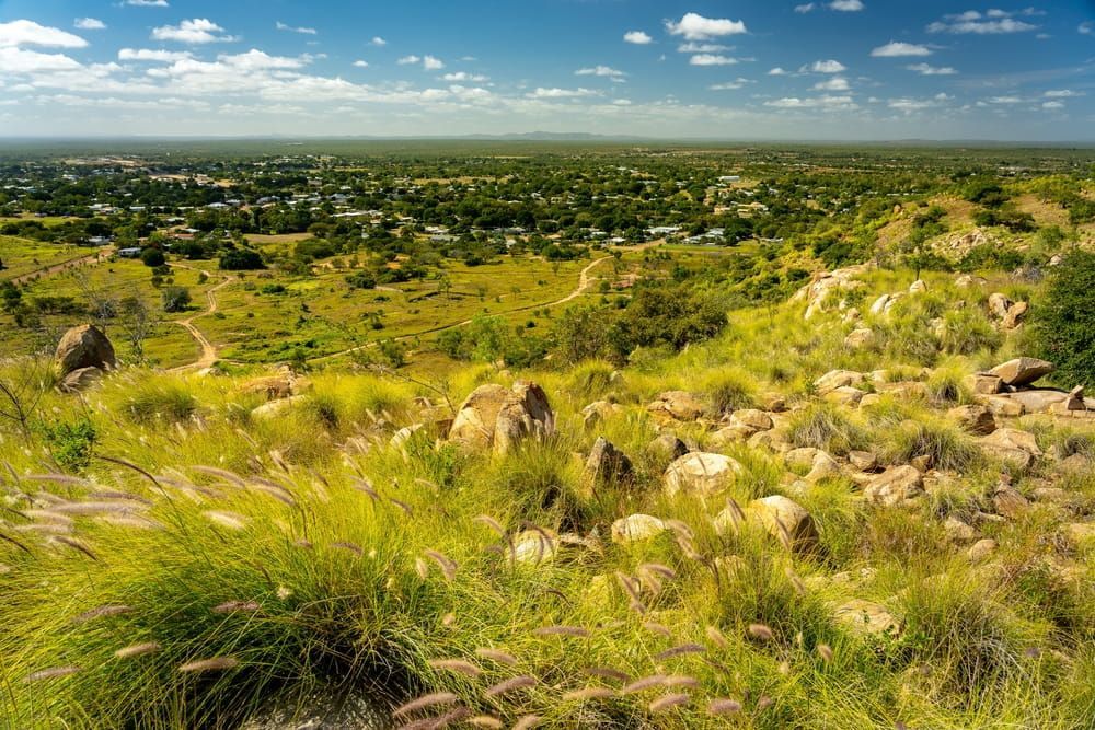 A View Of A Lush Green Field With A Small Town In The Distance — Day & Night Towing & Transport In Charters Towers, QLD