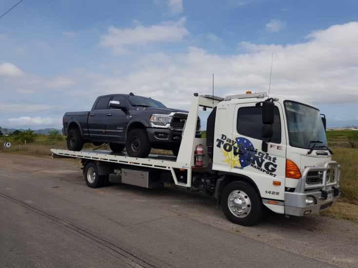 A Tow Truck With A Truck On The Back Of It — Day & Night Towing & Transport In Condon, QLD