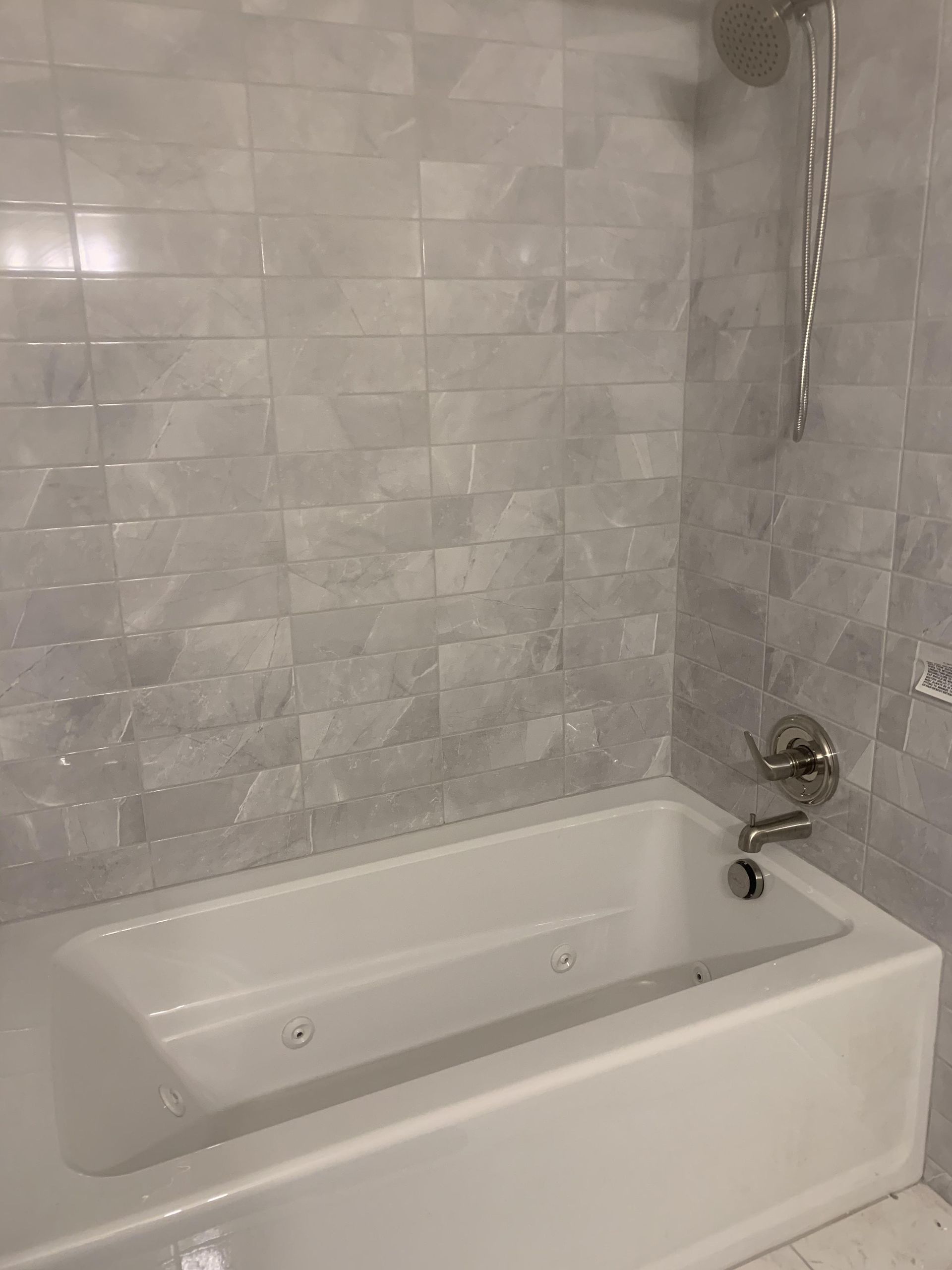 A bathroom with a bathtub and a shower.