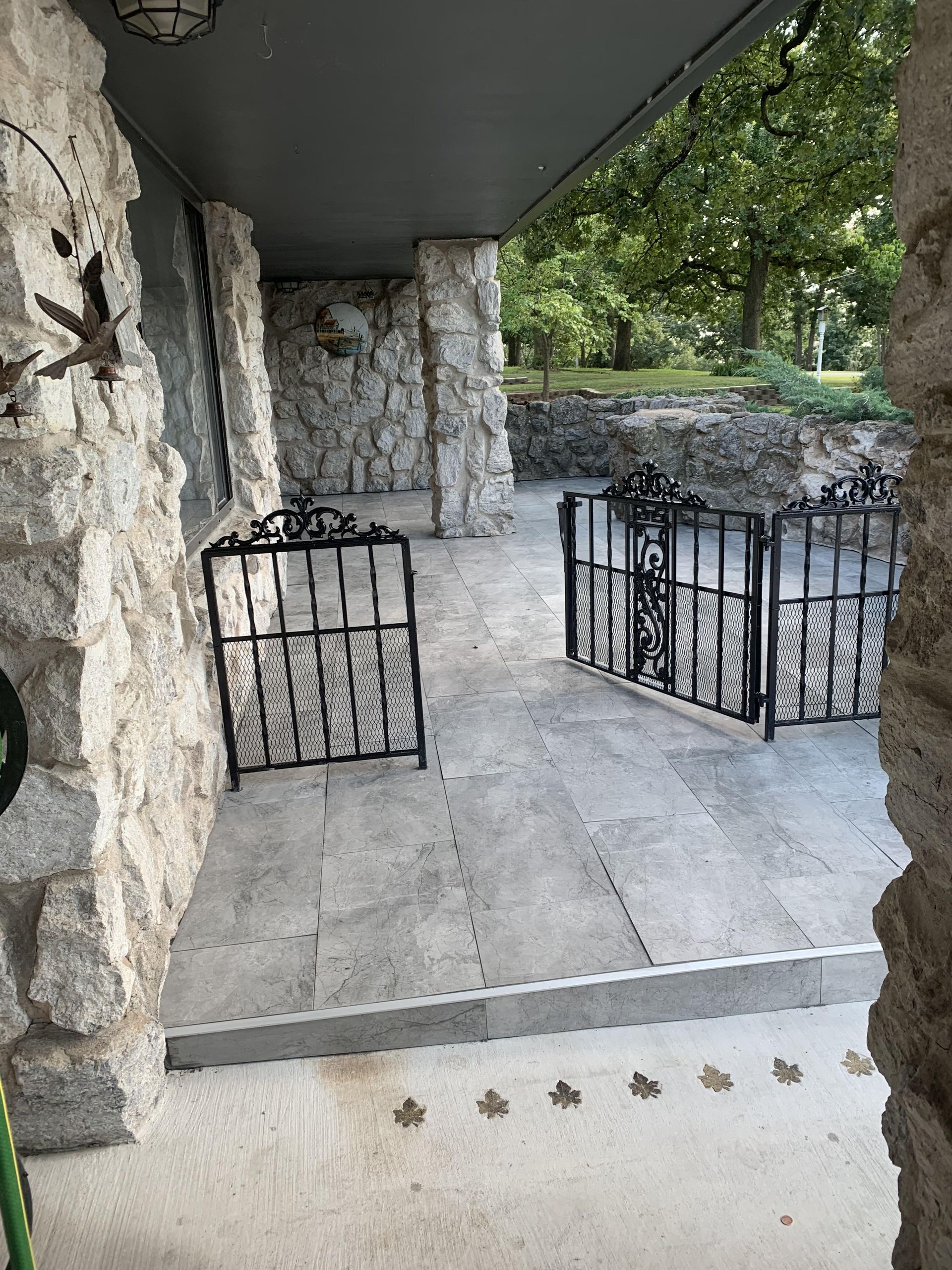 A stone wall with a wrought iron gate in front of it