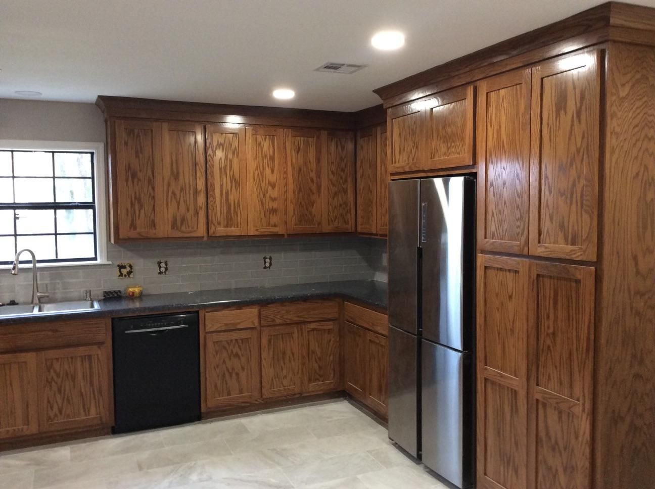 A kitchen with wooden cabinets and stainless steel appliances.