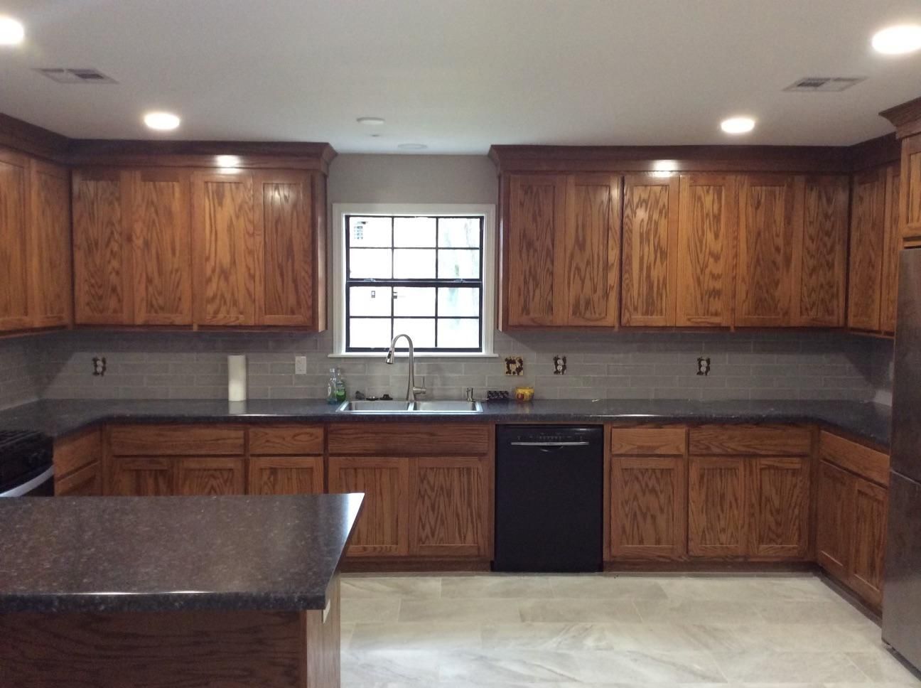A kitchen with wooden cabinets and granite counter tops
