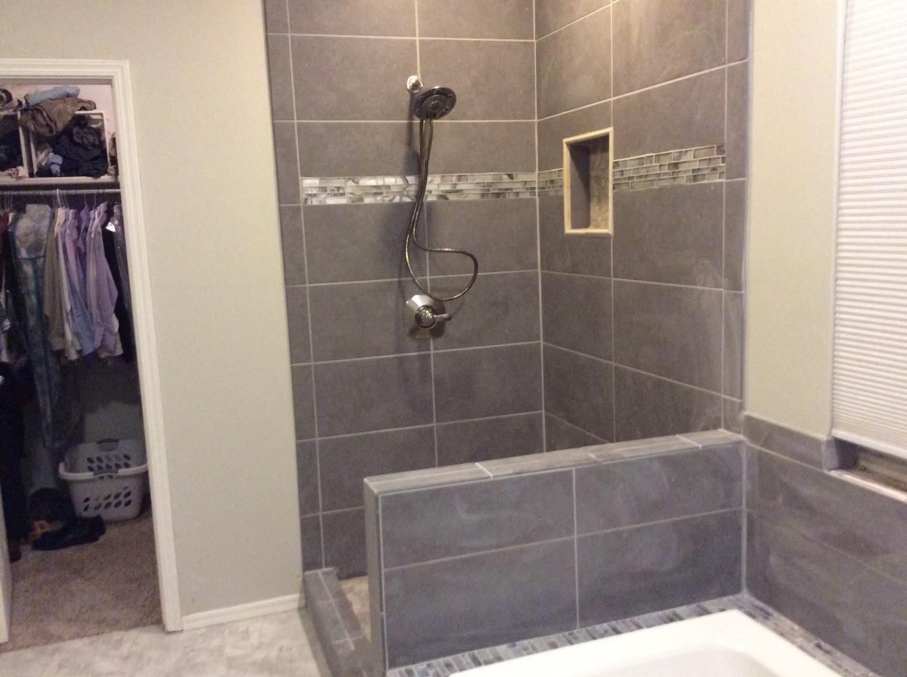 A bathroom with a walk in shower and a bathtub