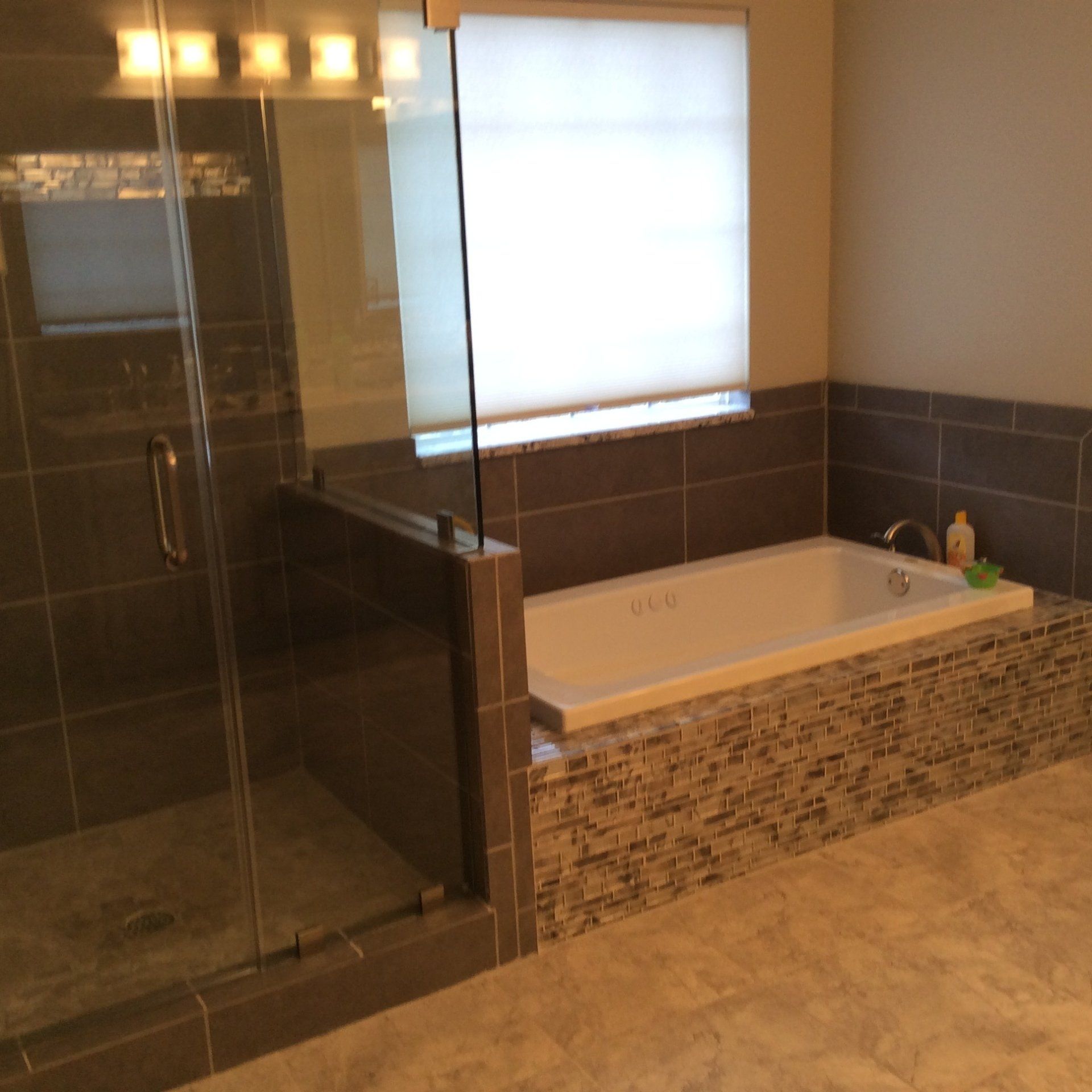 A bathroom with a bathtub and a walk in shower