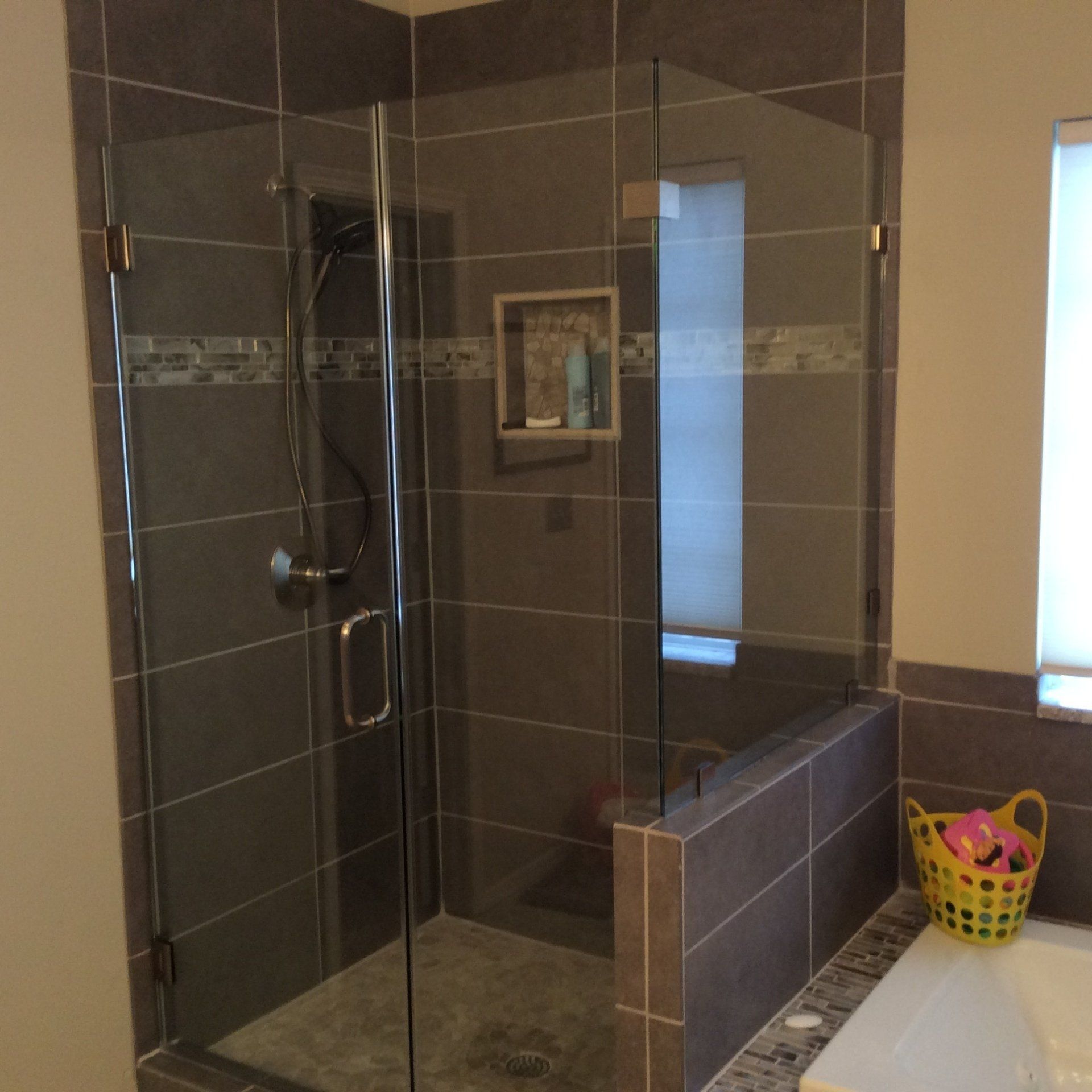 A bathroom with a walk in shower and a bathtub