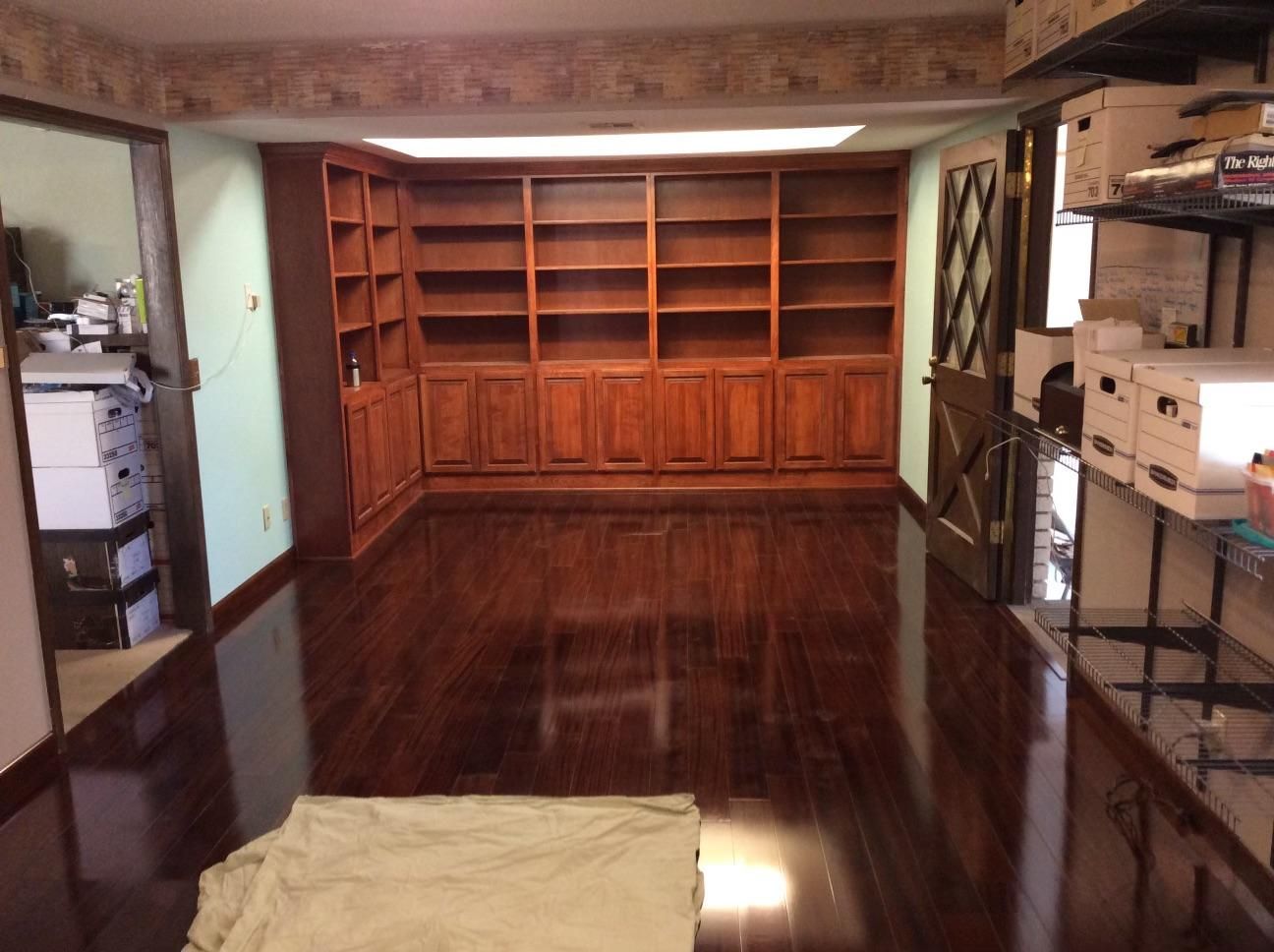 An empty room with wooden shelves and cabinets