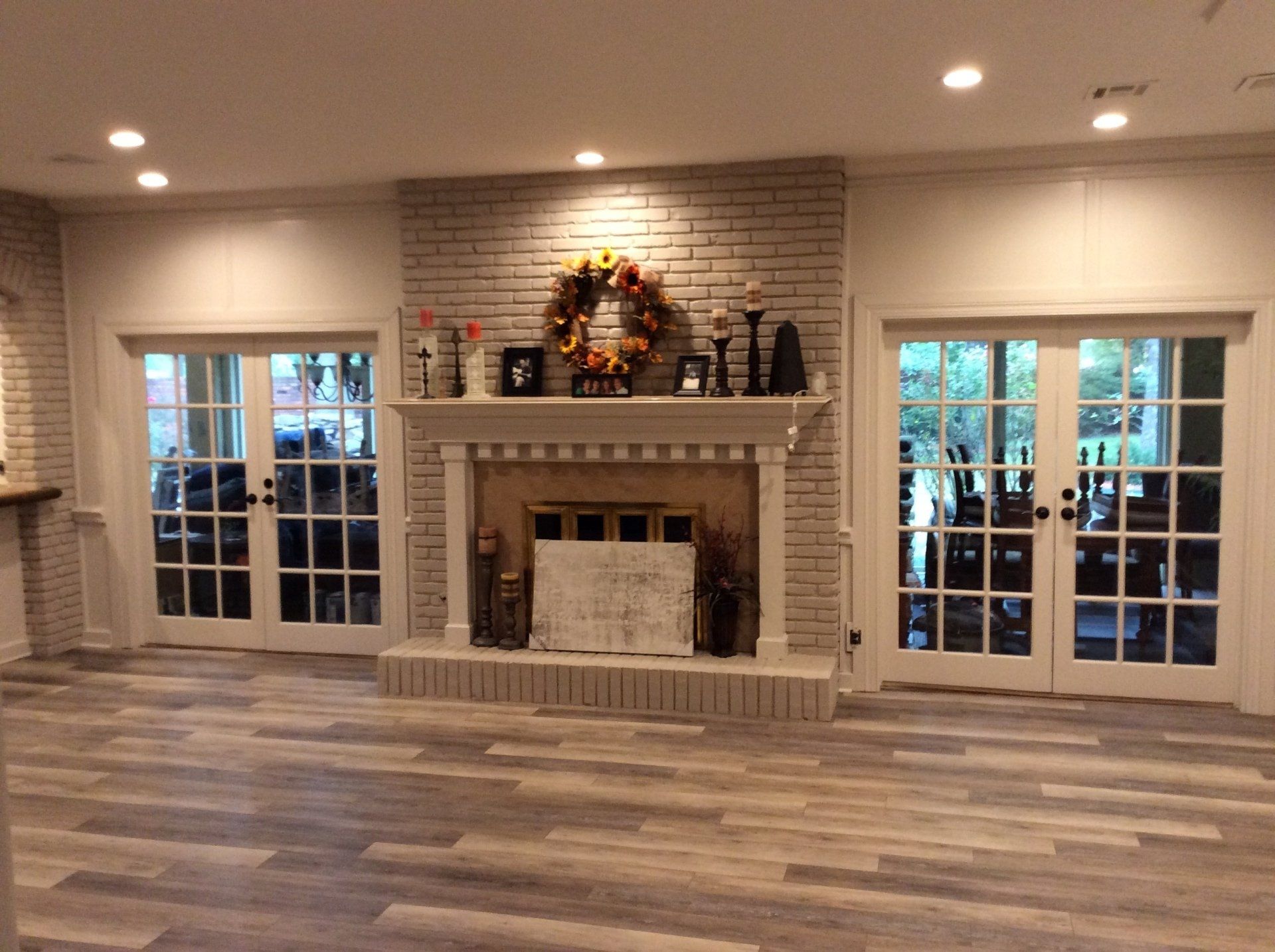 A living room with a fireplace and french doors