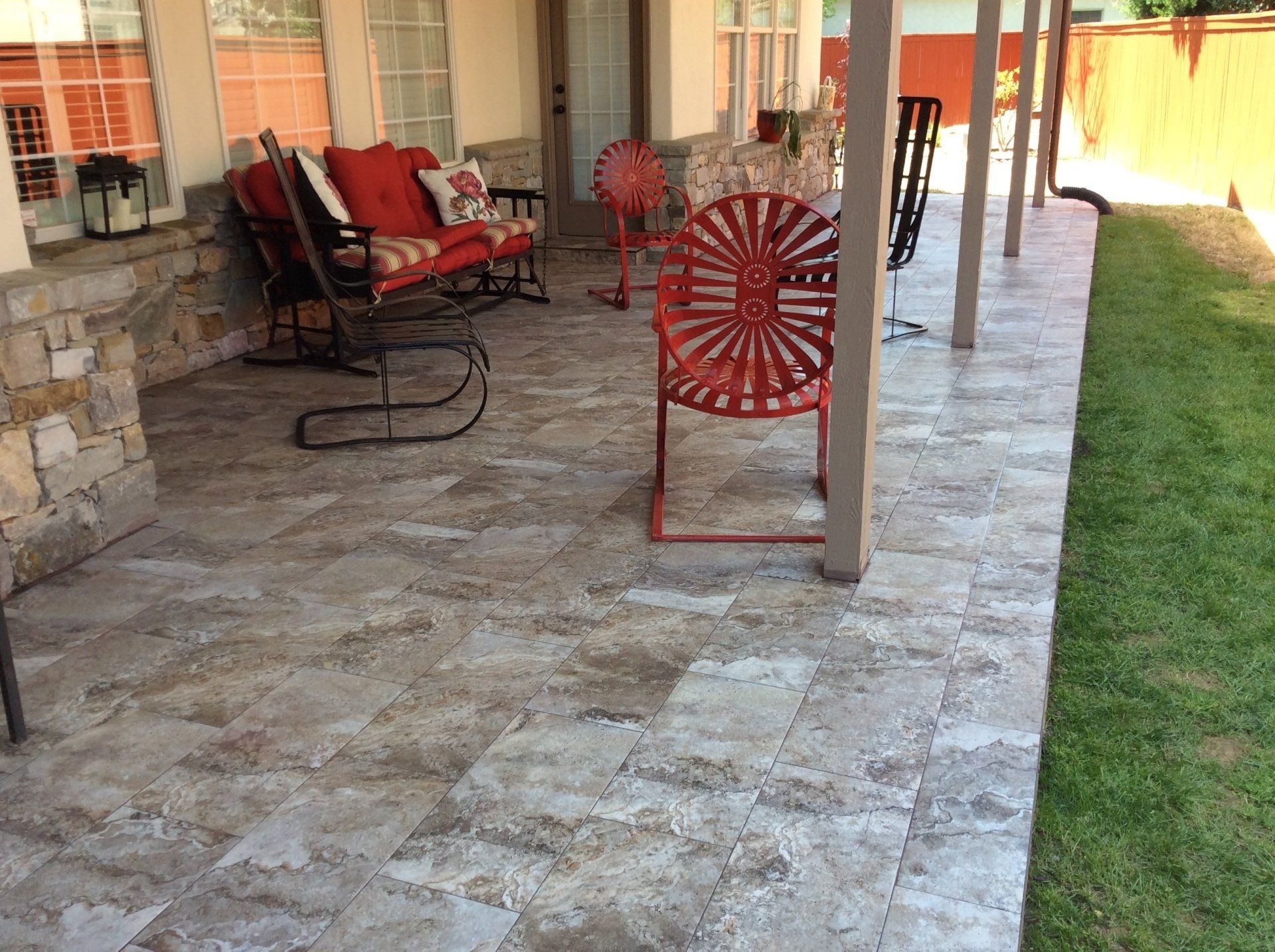 A patio with a couch and chairs on it