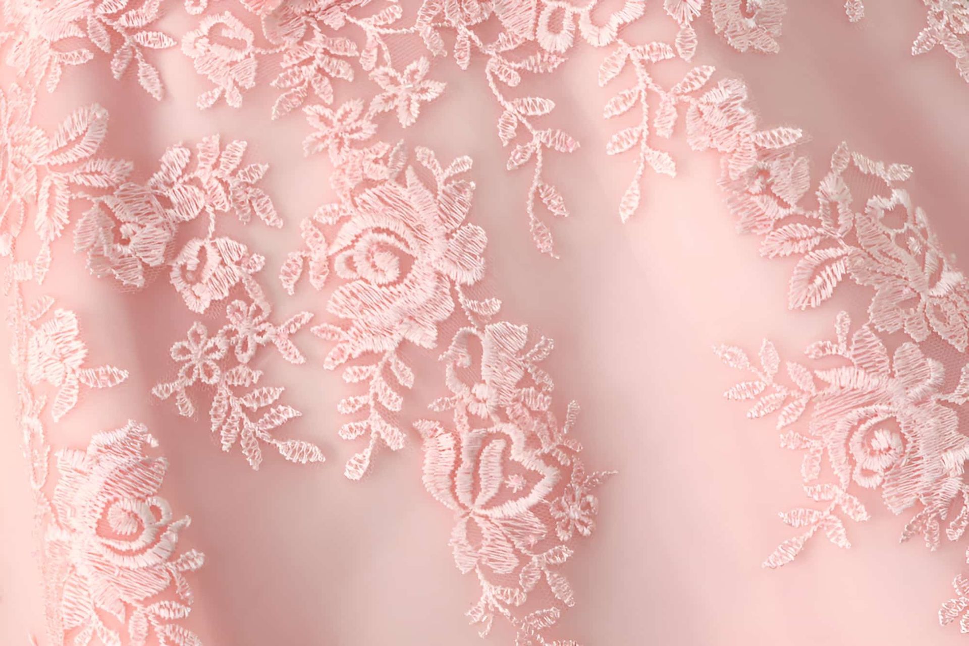 A Close Up Of A Pink Lace Fabric With A Floral Pattern — Gympie Embroidery Services In Southside, QLD