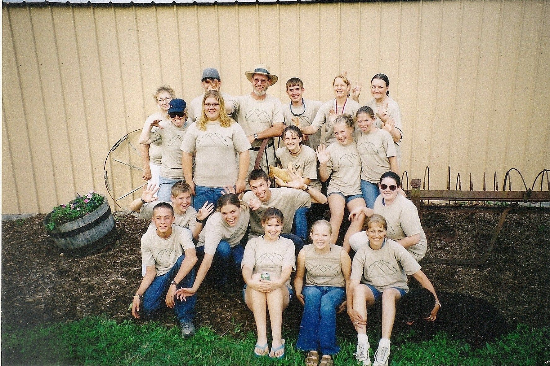 A group of people posing for a picture in front of a building