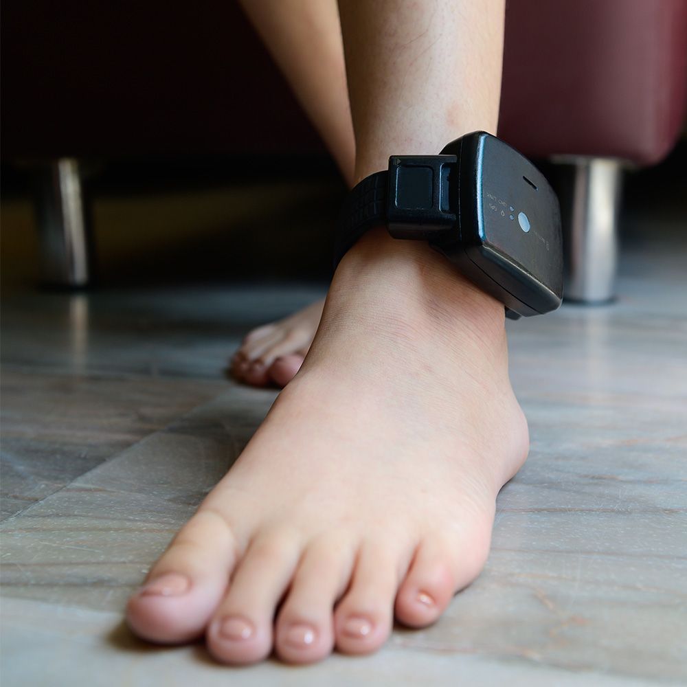 A close up of a person 's foot with a bracelet on it