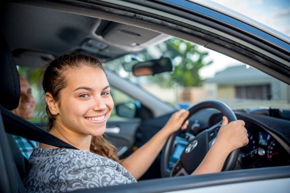 Man Smiling with Two Car — Driving School in Townsville QLD
