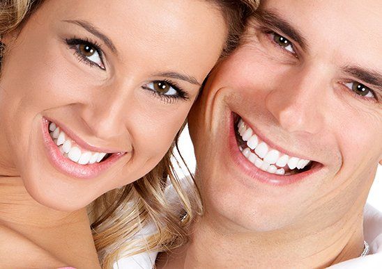 Family Dental Office — Couple Smiling with White Teeth in Livonia, MI