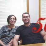 A man and a woman are sitting next to each other at a table.