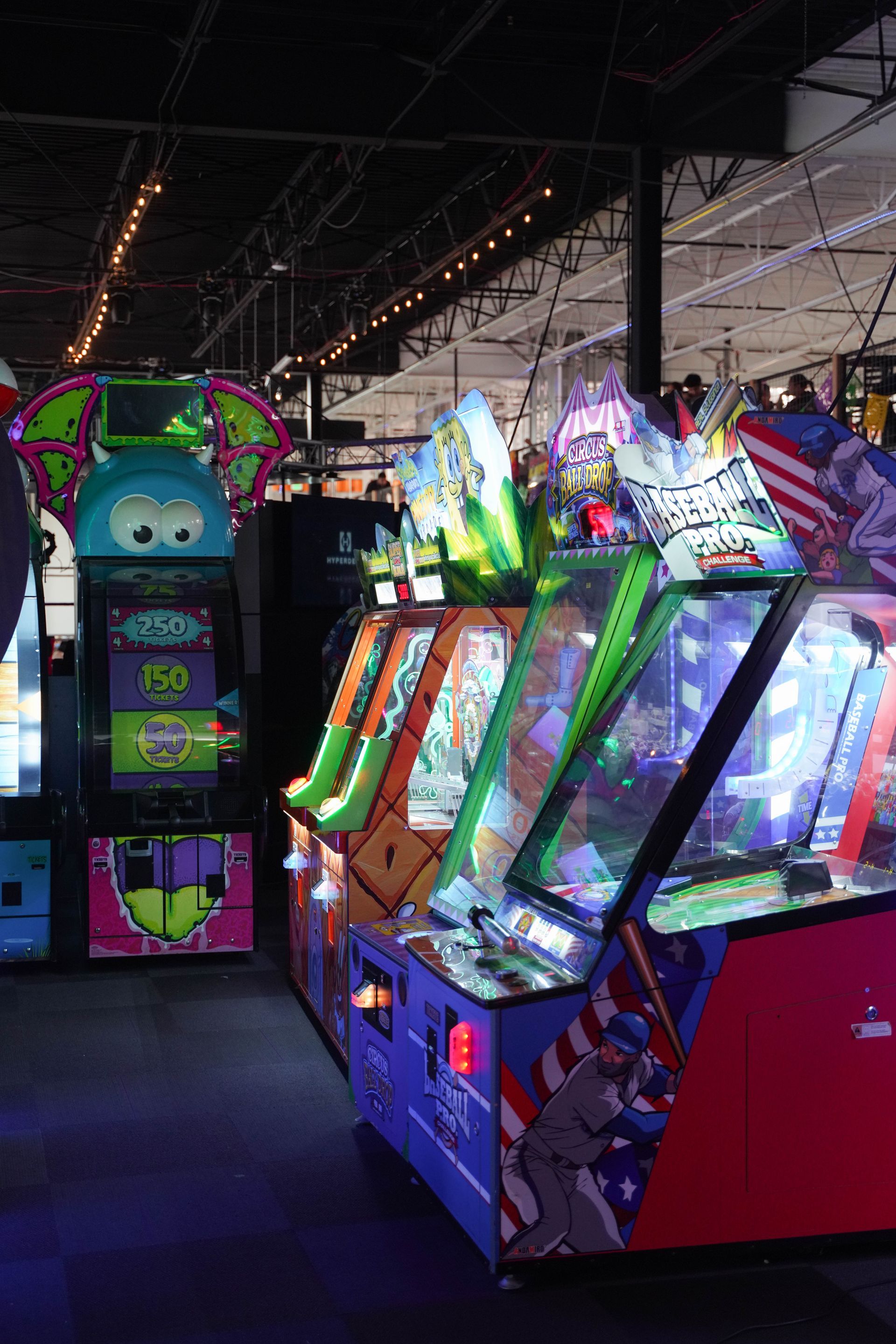 Shelves stocked with various boxed toys and games in a store, with bright packaging and a dark background.