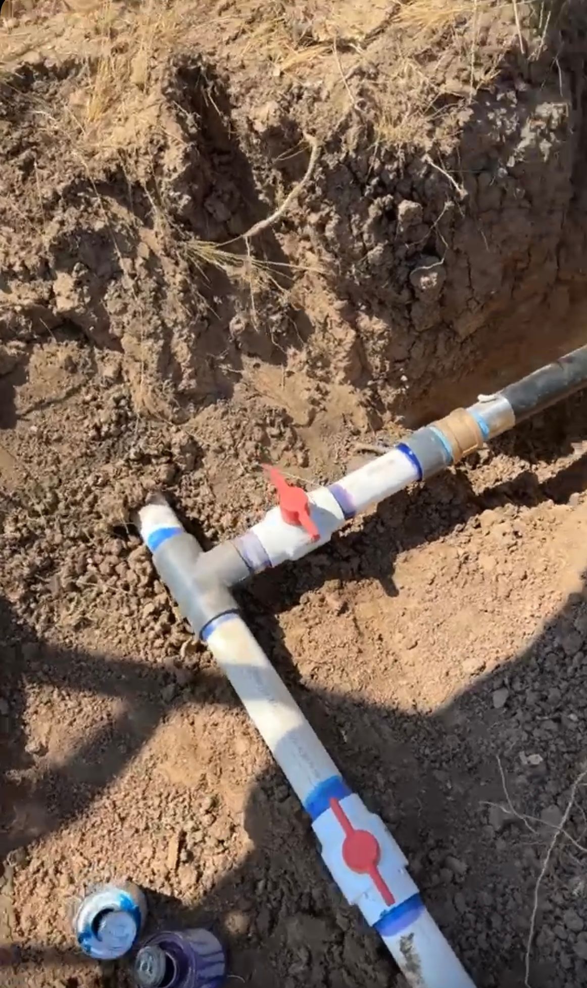 Water pipes with valves buried in the ground.