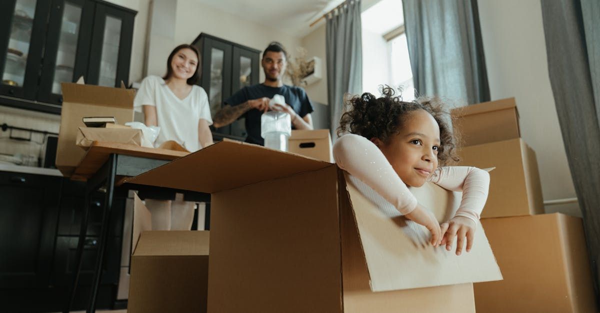 family unpacking moving boxes