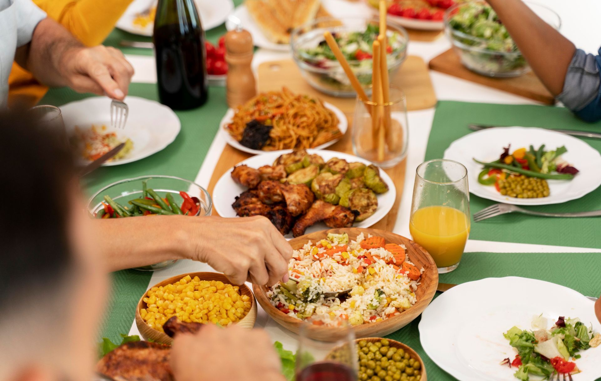 A group of people are sitting at a table eating food.