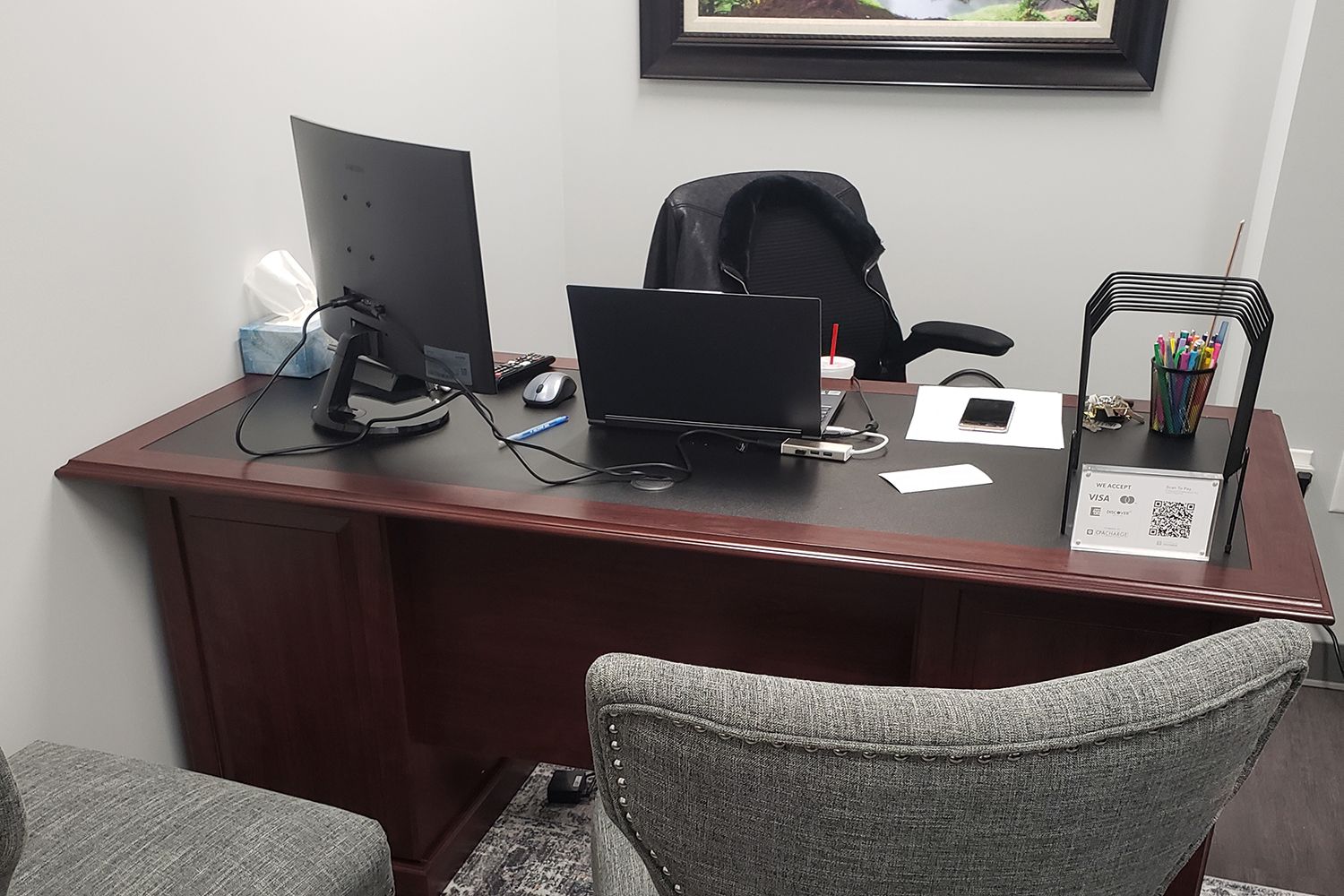 A desk with a laptop and a computer on it