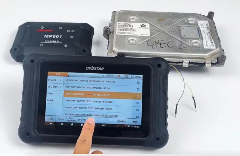 A person is using a tablet to diagnose a car.