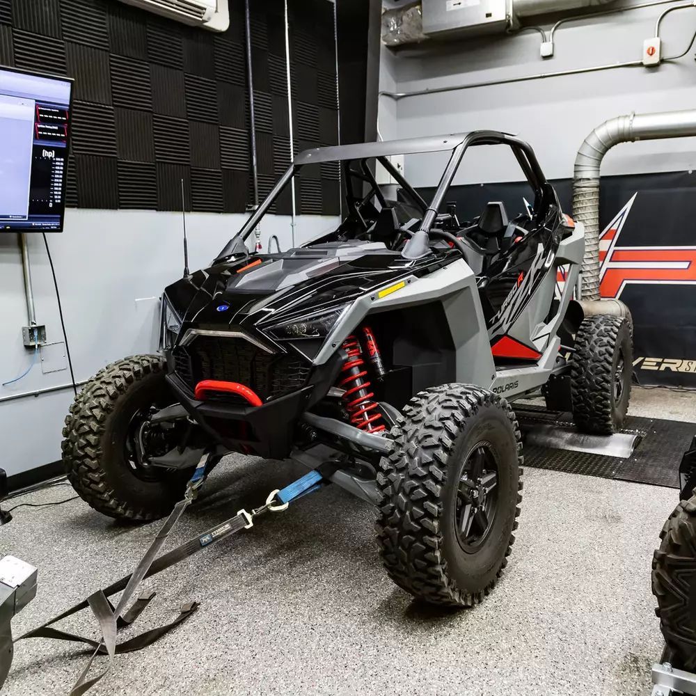 A polaris rzr xp turbo is being tested in a garage.
