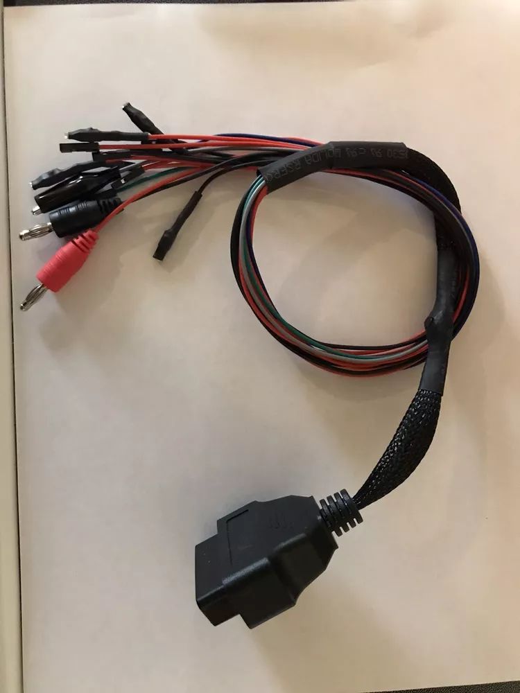 A bunch of wires are laying on a white surface