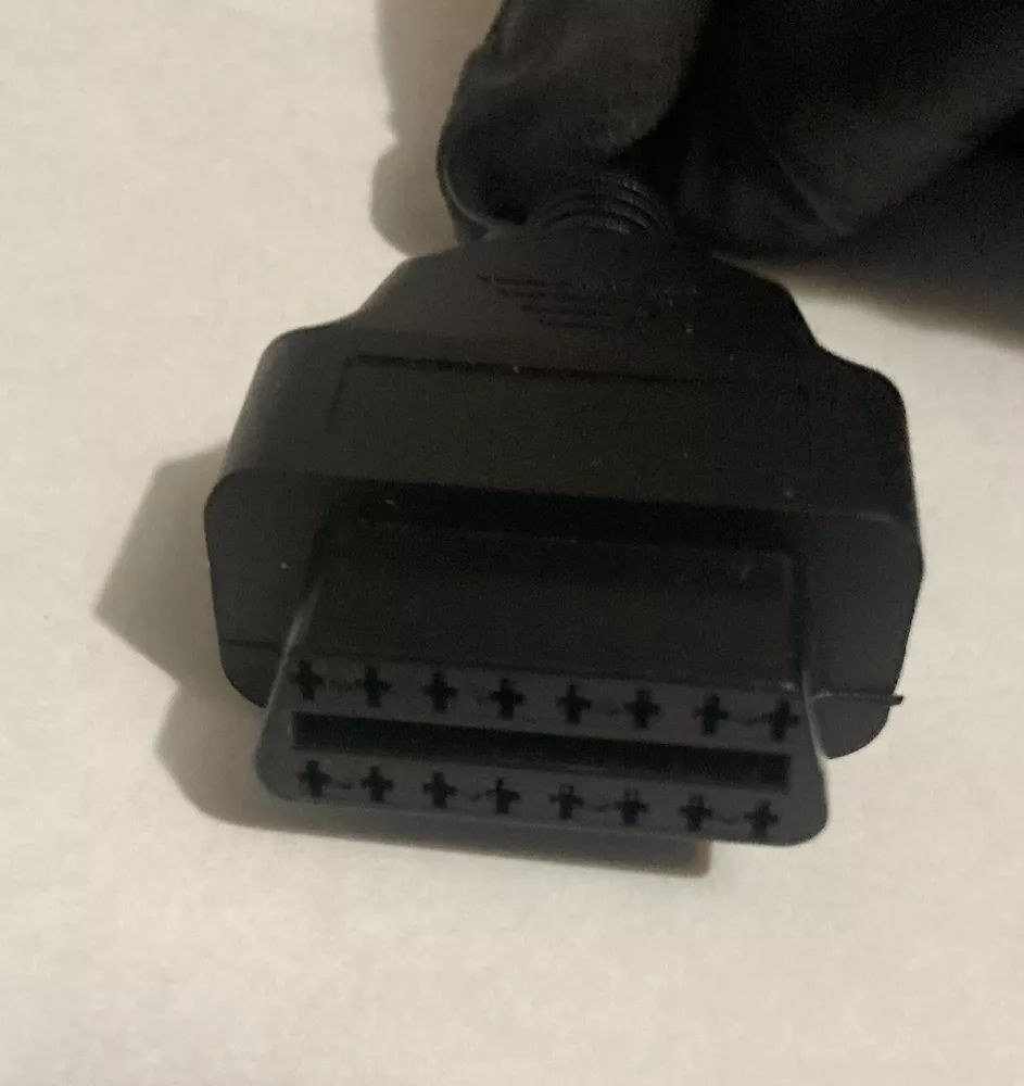 A close up of a black connector on a white surface