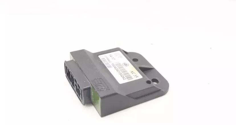 A black electronic device is sitting on a white surface.