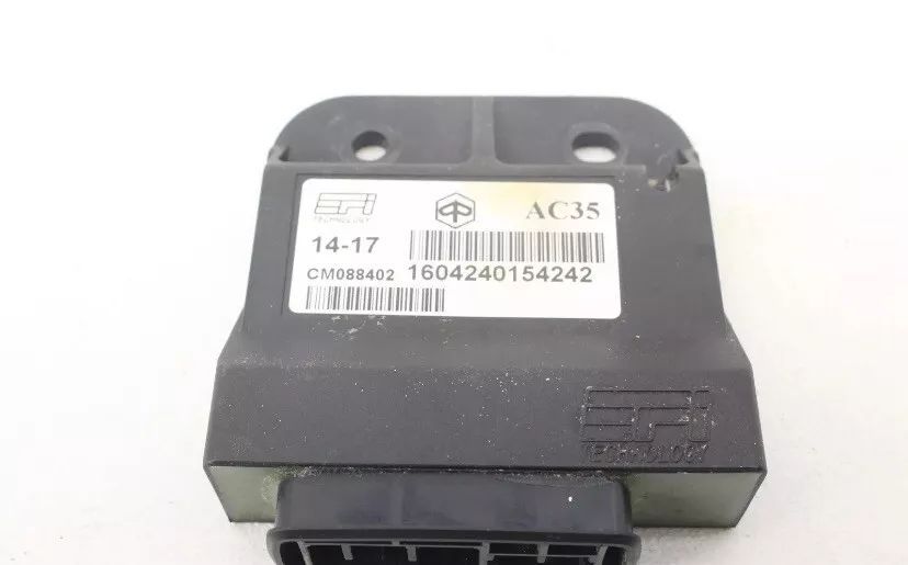 A black electronic device is sitting on a white surface.