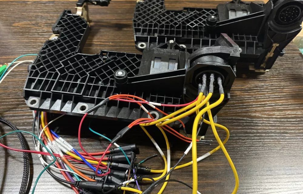 A bunch of wires are laying on a wooden table